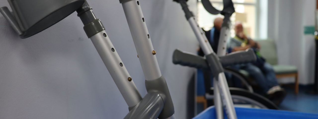 Several mobility crutches standing up in a blue box